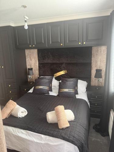 a bedroom with two beds with black and white pillows at Dottys lodge in Felton