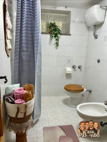 a bathroom with a toilet and a sink and a shower at Casa Palumbo in Bacoli