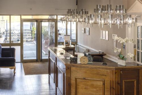a kitchen with a counter and a chandelier at The Jephson Hotel; BW Signature Collection in Leamington Spa