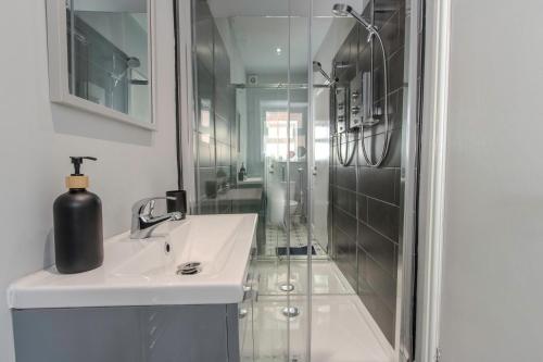 a bathroom with a sink and a shower at The Southport Seaside Snug Suites in Southport