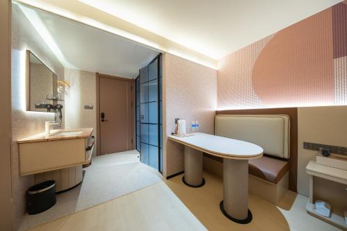 a bathroom with a table and a sink at Zhuoya Garden Hotel in Beijing