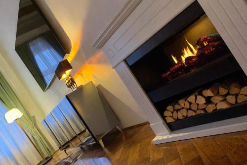 a fireplace in a living room with a fire place at Studio Balcescu in Sibiu