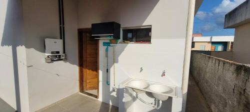 a bathroom with a sink in the side of a building at Casa aconchegante e estruturada in Bragança