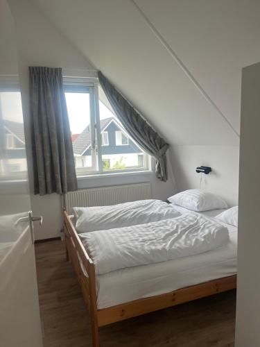 a bedroom with two beds and a window at Ark in Terherne