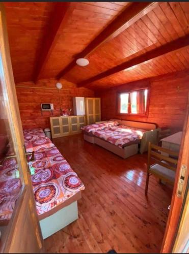 a bedroom with two beds in a wooden cabin at Chatka pri vode aj pre rybárov 3 in Galanta