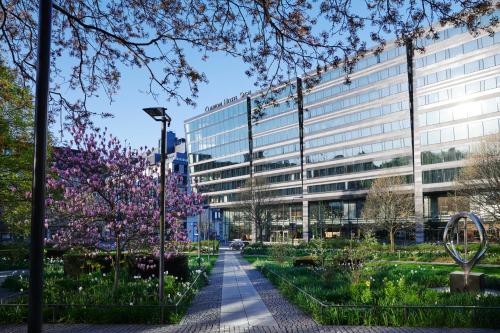 an office building with a garden in front of it at Clarion Hotel Sign in Stockholm