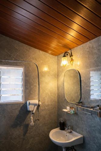 a bathroom with a sink and a mirror at Sierra Vista Resort in Nashik