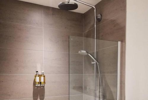 a bathroom with a shower with a glass door at Pennan - 2 Bed Luxury Apartment by Together Travel in Wick