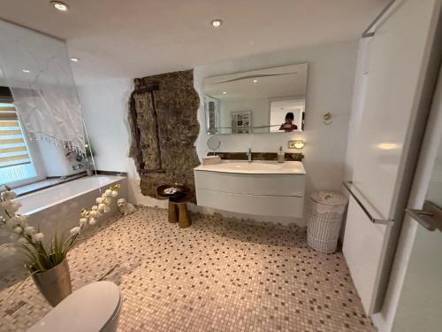 a bathroom with a tub and a sink and a mirror at Luxus Domizil in Villingen-Schwenningen