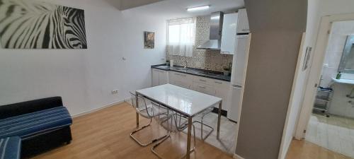 a small kitchen with a table and a counter top at Catedral Larios Centro in Málaga