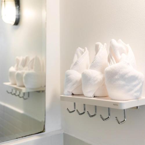a shelf filled with white towels in a bathroom at Allrange Home 5 bedroom for 10 guests in Chiang Mai