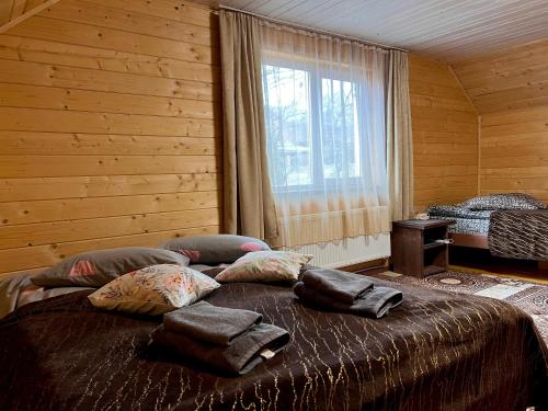 a bedroom with a large bed with pillows on it at Карпатський котедж Karpatian cottage in Vorokhta