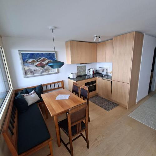 a kitchen with a table and a dining room at Hemmile - Ferienwohnung in Lech in Lech am Arlberg