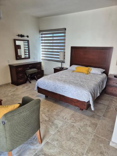 a bedroom with a bed and a desk and a chair at Hotel Lorimar in La Paz