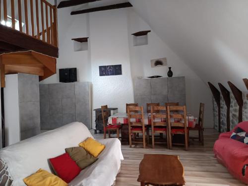 a living room with a couch and a table and chairs at Grand Duplex 9 pers-Centre de La Bourboule in La Bourboule