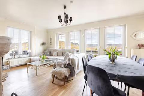 a living room with a table and a couch at La Villa des Hauts Chênes in Bouillon