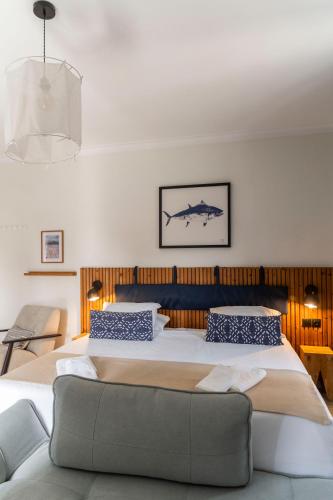 a bedroom with a large bed and a couch at WOT Costa da Caparica Soul in Costa da Caparica
