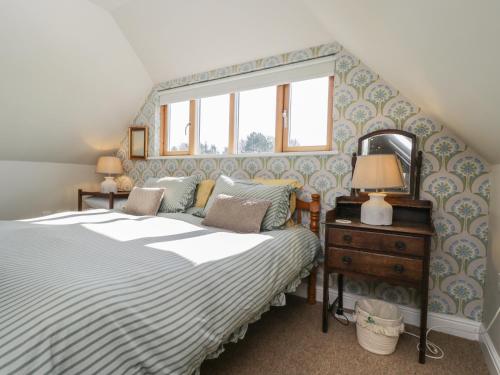 a bedroom with a bed and a window at The Hideaway Loft in Chippenham