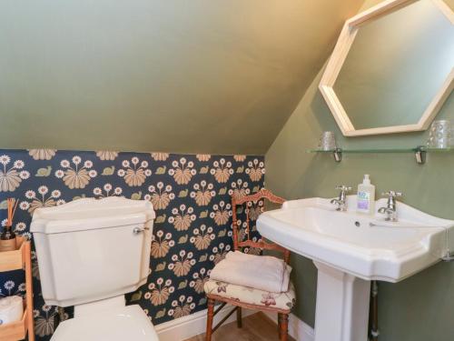 a bathroom with a white toilet and a sink at The Hideaway Loft in Chippenham