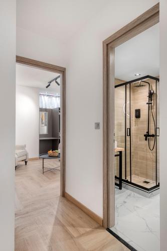 a pivot door in a room with a shower at Athenian Heart Suites in Athens
