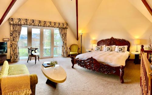 a bedroom with a large bed and a living room at Falls of Lora Hotel in Oban