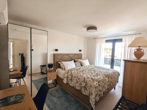 a bedroom with a bed and a desk and a window at Seaview Residence Krk 2 Bedrooms 2 Bathrooms Free Parking in Krk