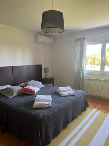 a bedroom with a bed with two towels on it at Quinta da Corticeira in Elvas