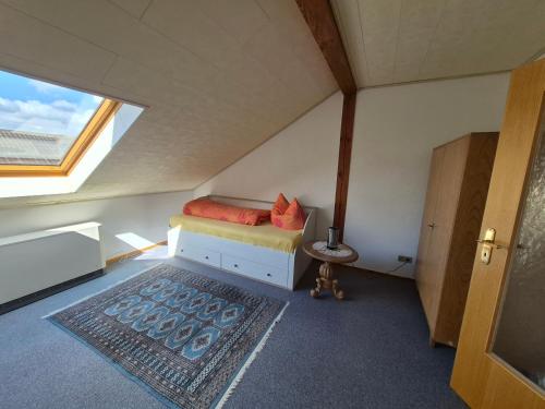 a small bedroom with a bed in a attic at Unterkunft Julian in Waghäusel