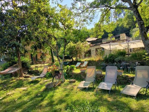 a group of chairs sitting in the grass in a yard at Agricampeggio Boschetto Gioioso in Barbiano