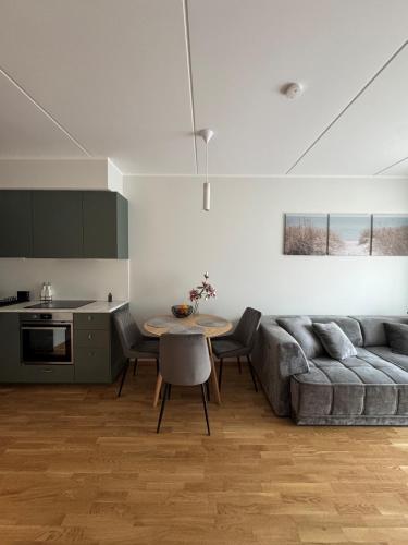 a living room with a couch and a table at Loo Apartment in Loo