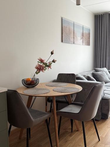 a table and chairs in a living room with a couch at Loo Apartment in Loo
