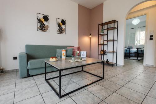 a living room with a couch and a table at Ionian Luxury Apartments in Perama