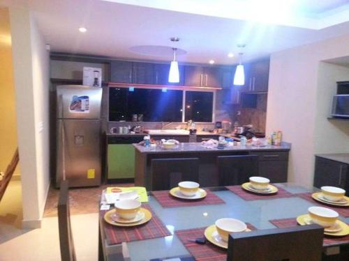 a kitchen with a table with dishes on it at Playa Almendro Resort in Tonsupa