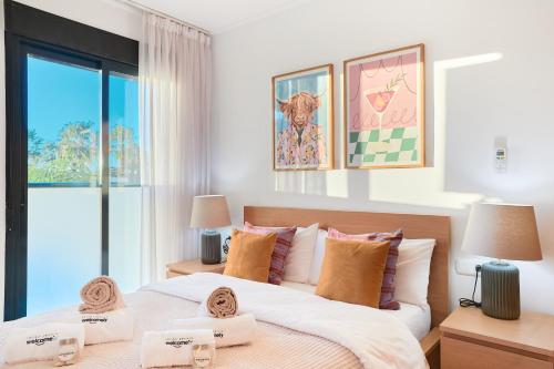 a bedroom with two beds and a window at Las Dunas 213 - by Welcomely in Oliva