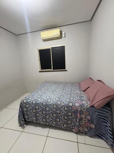 a small bedroom with a bed and a window at Casa Timon in Timon