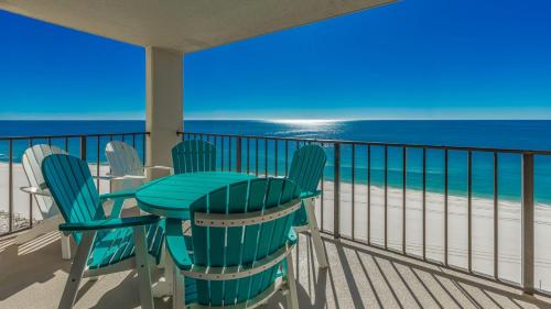 a balcony with a table and chairs and the ocean at Phoenix III 3126 in Orange Beach