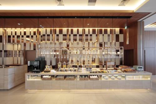 a restaurant with a buffet of food on display at Candeo Hotels Nankai Wakayama in Wakayama