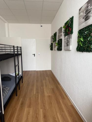 a room with a bunk bed and a hallway at Hostel Terre in Fellbach