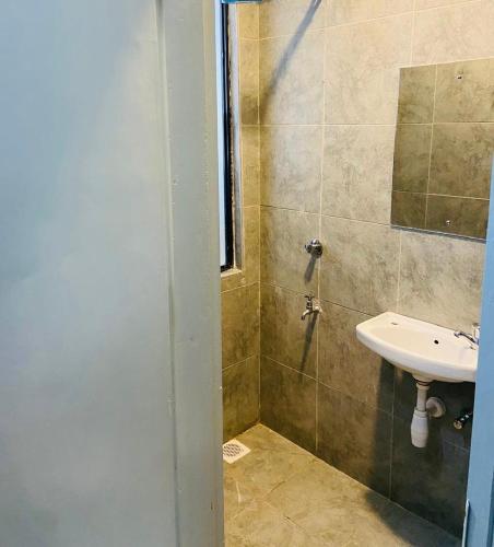 a bathroom with a sink and a shower at Haven stay in Kiambu