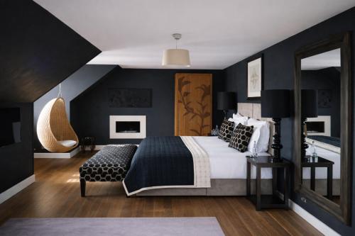 a bedroom with black walls and a bed and a mirror at Tigerlily in Edinburgh