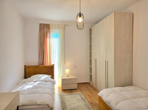 a bedroom with two beds and a cabinet and a window at Bay Breeze 293 in Lalzit Bay