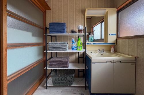 a bathroom with a sink and a mirror at Bunkyo in Naoshima