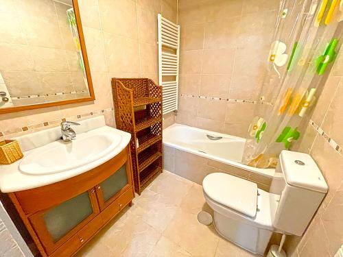 a bathroom with a sink and a toilet and a tub at Apartamentos Las Margas Sabiñánigo 3000 in Sabiñánigo