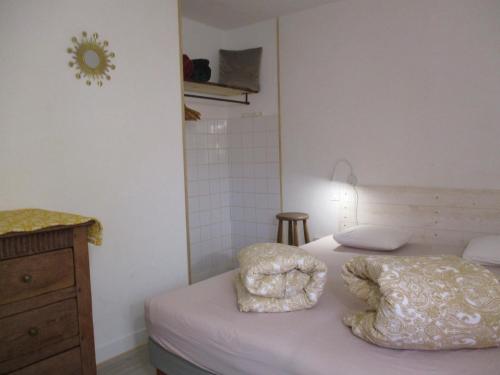 a bedroom with a bed with two pillows on it at La Source - 85 m2 & terrasse privée in Orcival