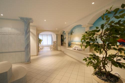 a large hallway with a bedroom and a potted plant at Bolero Appartements in Zermatt