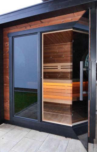 a sliding glass door on a house with a window at Landhaus Meine Auszeit in Bodenmais