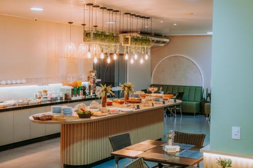 a restaurant with a long counter with food on it at Dallas Hotel in Palotina