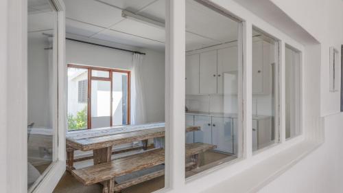 a room with a wooden bench and a window at 206 On Main in Agulhas
