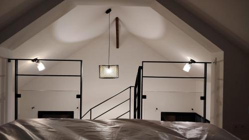 a bedroom with two white doors and two lights at Le petit marais in Le Mans