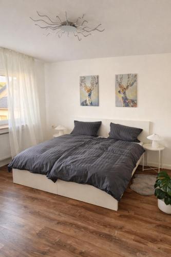 a bedroom with a bed and a chandelier at Jaegersruh Vicht in Fleuth